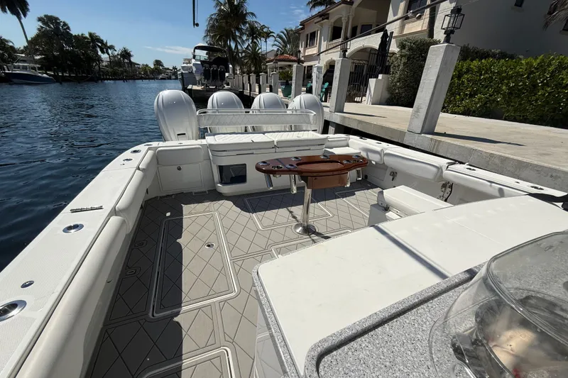 Slide: The Image of 2019 HCB 53 Suenos boat interior with seating and table, docked by waterfront homes. - 31