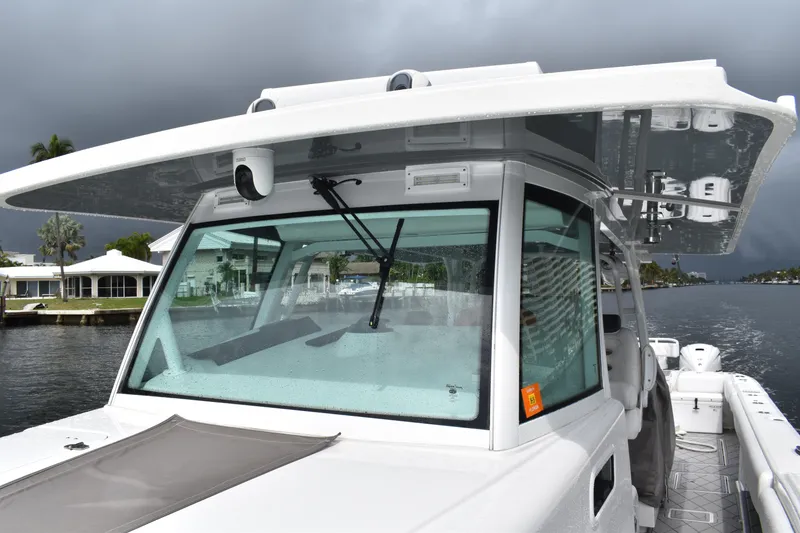 Slide: The Image of 2019 HCB 53 Suenos boat with sleek design, docked under cloudy skies. - 34