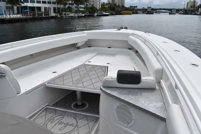 Slide: The Image of 2019 HCB 53 Suenos boat interior with seating and table on a calm waterway. - 36