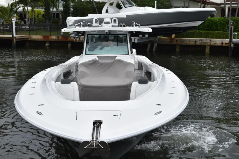 Slide: The Image of 2019 HCB 53 Suenos luxury boat docked in a marina, showcasing sleek design and spacious deck. - 6
