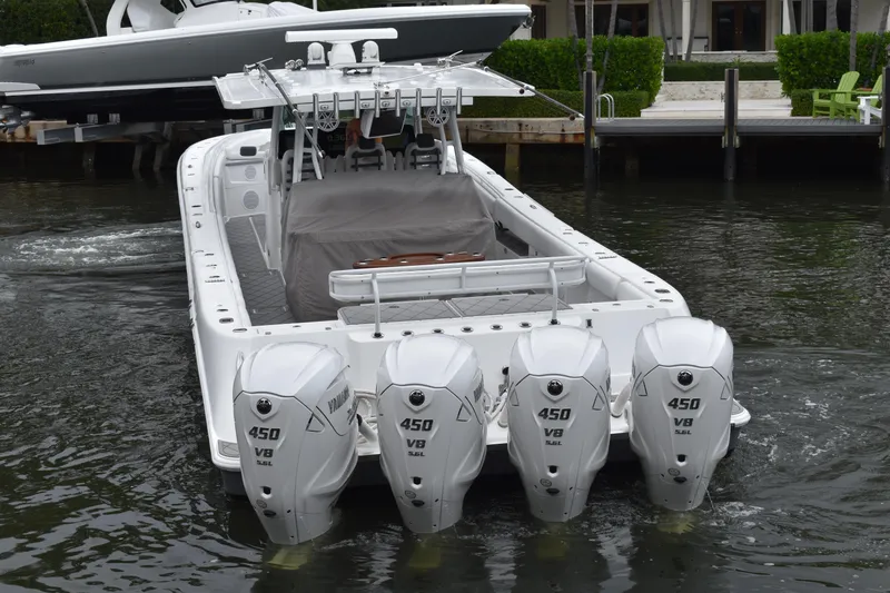 Slide: The Image of 2019 HCB 53 Suenos boat with four Yamaha 450 V8 engines, docked in a marina. - 7