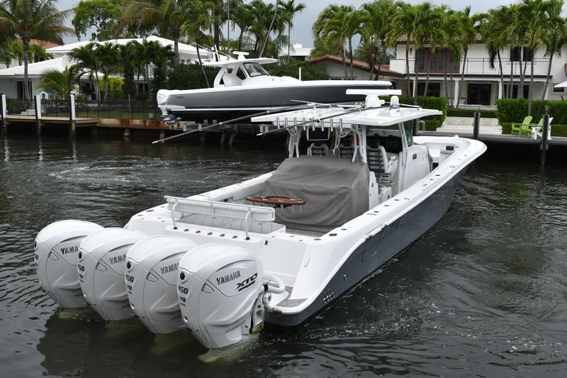 Slide: The Image of 2019 HCB 53 Suenos boat with four Yamaha engines docked near waterfront homes. - 8
