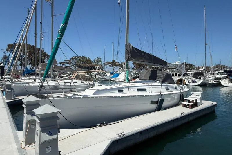 Slide: The Image of 2001 Beneteau Oceanis 361 sailboat docked at a marina under clear blue skies. - 1