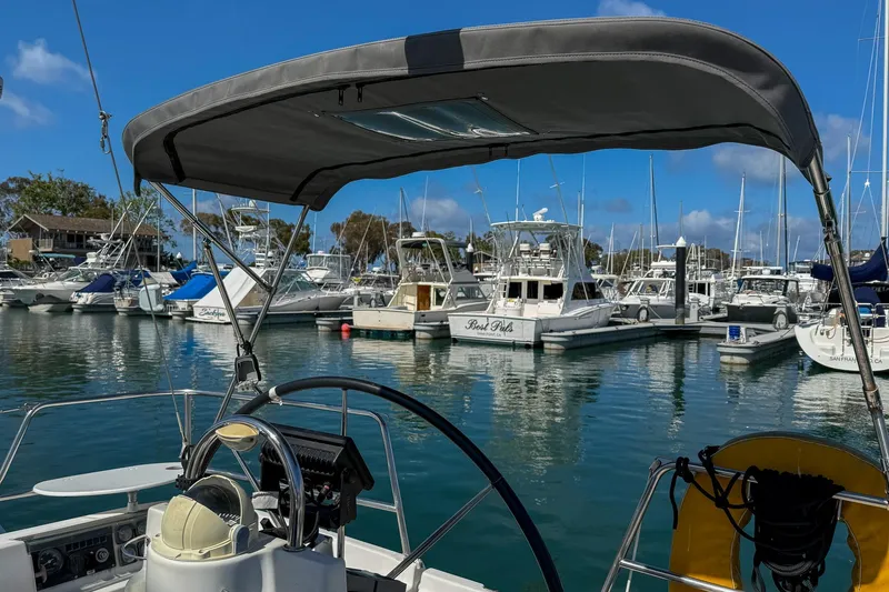 Slide: The Image of Cockpit of 2001 Beneteau Oceanis 361 sailboat with wooden table and steering wheel. - 11