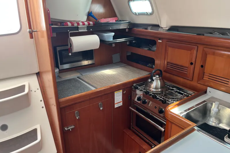 Slide: The Image of Cozy cabin interior of 2001 Beneteau Oceanis 361 sailboat with blue bedding. - 20