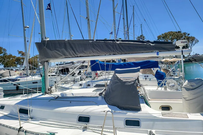 Slide: The Image of 2001 Beneteau Oceanis 361 sailboat docked in a marina, featuring a covered cockpit. - 3