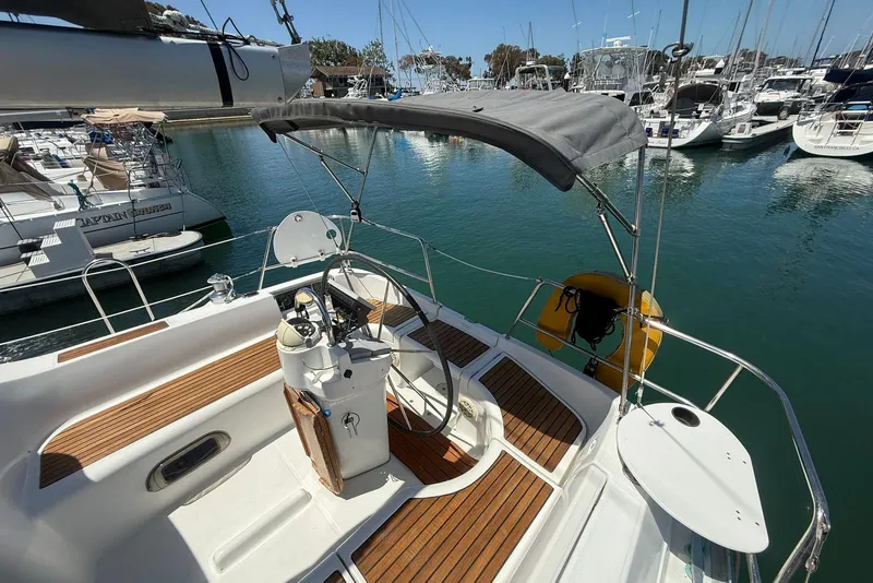 Slide: The Image of Cockpit view of 2001 Beneteau Oceanis 361 sailboat, featuring steering wheel and navigation equipment. - 6