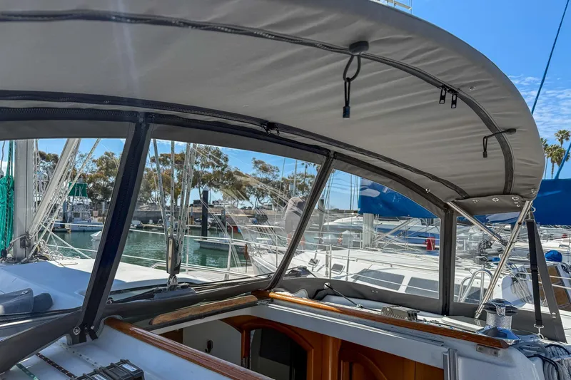 Slide: The Image of Beneteau Oceanis 361 sailboat in marina, showcasing helm and canopy, 2001 model. - 9