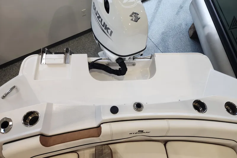 Slide: The Image of 2026 Stingray 172 DC boat with Suzuki outboard motor, featuring sleek white design. - 10