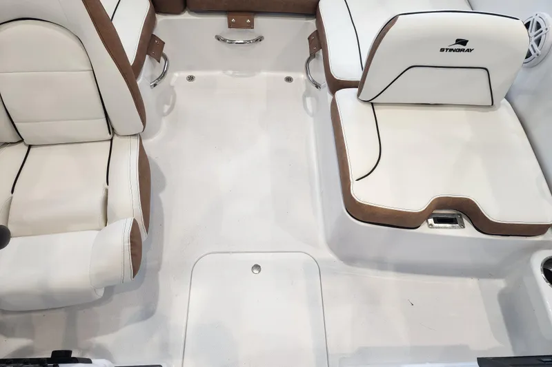 Slide: The Image of Interior of 2026 Stingray 172 DC boat with white and brown seating. - 12