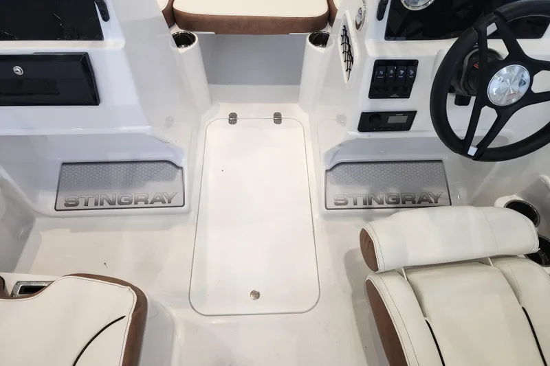 Slide: The Image of 2026 Stingray 172 DC boat interior with steering wheel and branded floor mats. - 13