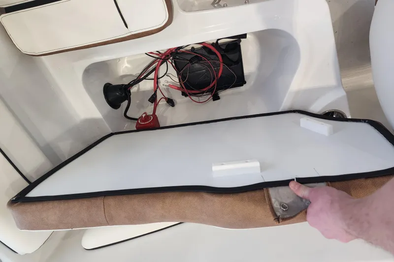 Slide: The Image of Interior view of a 2026 Stingray 172 DC boat showing wiring and storage compartment. - 15