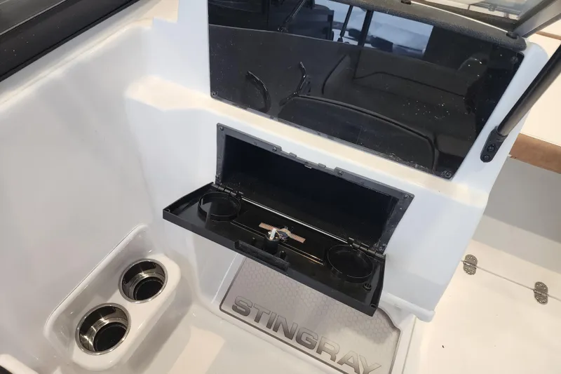 Slide: The Image of 2026 Stingray 172 DC boat interior with cup holders and storage compartment. - 18