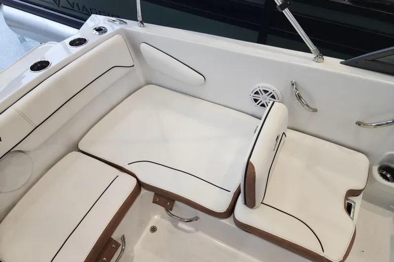 Slide: The Image of 2026 Stingray 172 DC boat interior with white cushioned seating and cup holders. - 20