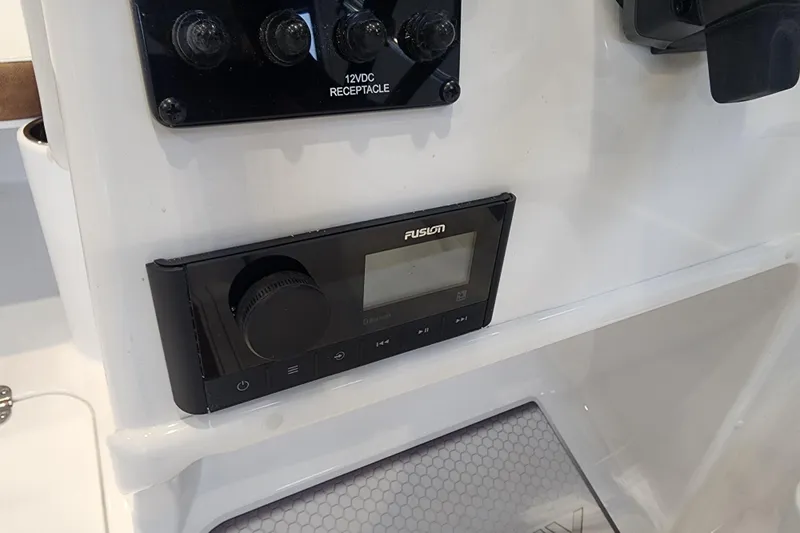 Slide: The Image of 2026 Stingray 172 DC boat dashboard featuring a Fusion audio system and 12VDC receptacle. - 23