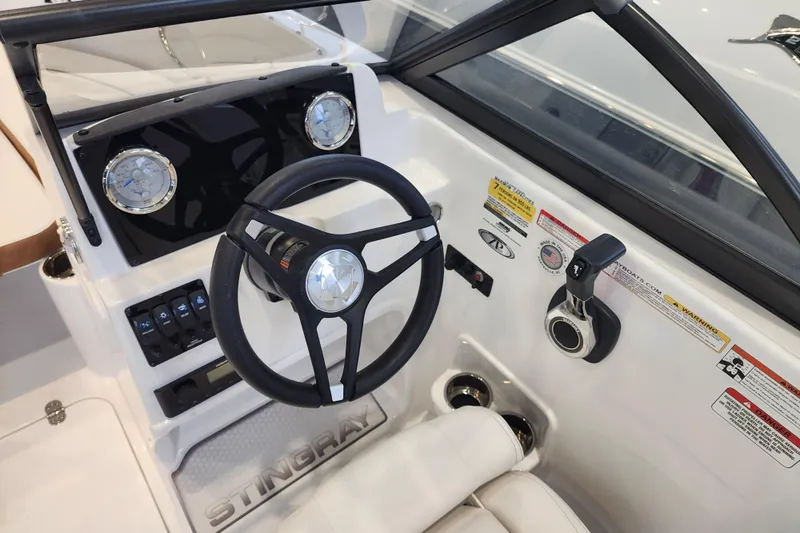Slide: The Image of 2026 Stingray 172 DC boat dashboard with steering wheel and control panel. - 24