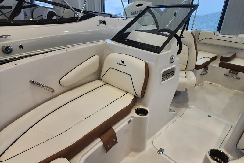 Slide: The Image of 2026 Stingray 172 DC boat interior with white and brown seating, modern design. - 26