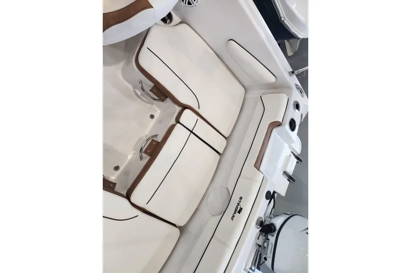 Slide: The Image of 2026 Stingray 172 DC boat interior with white cushioned seating and sleek design. - 8