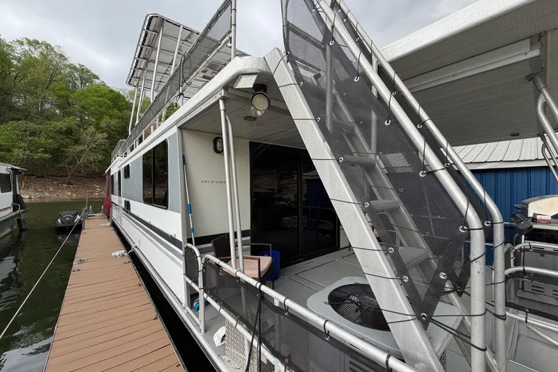 The Image of 1989 Sumerset 14x63 houseboat docked, featuring upper deck and modern amenities. - 1