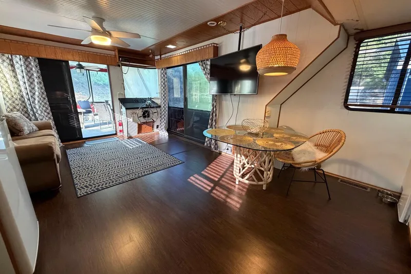 Slide: The Image of Interior of a 1989 Sumerset 14x63 houseboat with modern decor and natural lighting. - 10