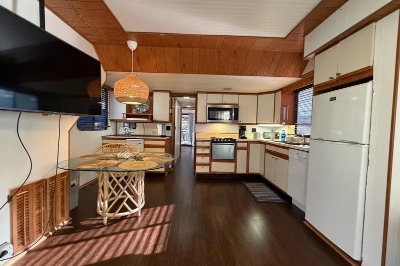 Slide: The Image of Cozy kitchen in 1989 Sumerset 14x63 houseboat with modern appliances and wooden accents. - 12