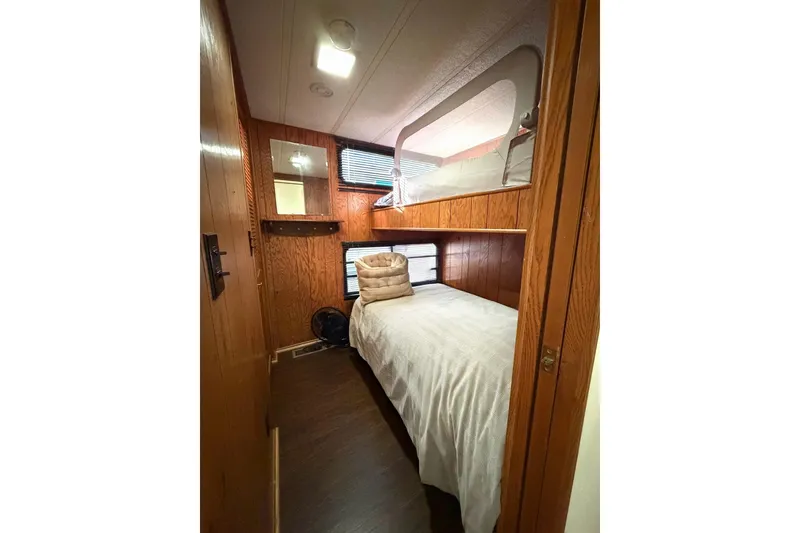 Slide: The Image of Cozy bedroom in 1989 Sumerset 14x63 houseboat with wood paneling and bunk beds. - 14