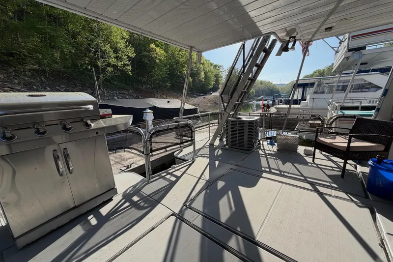 Slide: The Image of Outdoor deck of a 1989 Sumerset 14x63 houseboat with grill and seating area. - 24