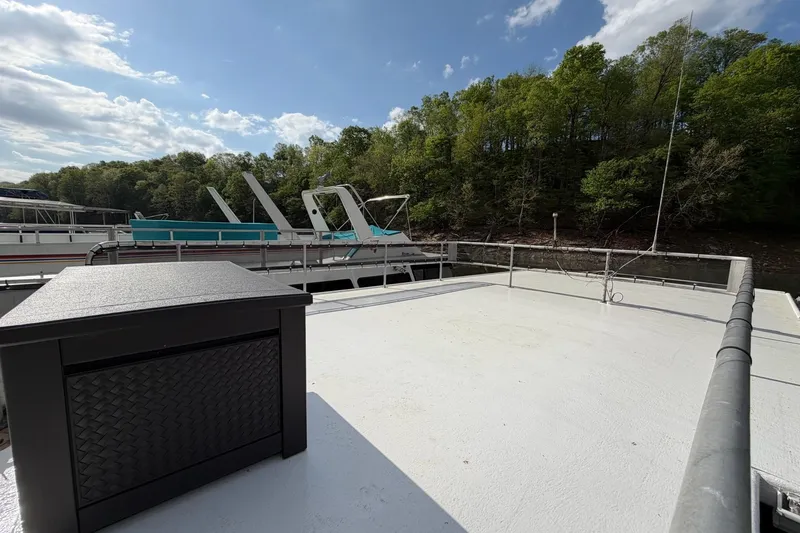 Slide: The Image of Rooftop view of a 1989 Sumerset 14x63 houseboat docked near a forested shoreline. - 29