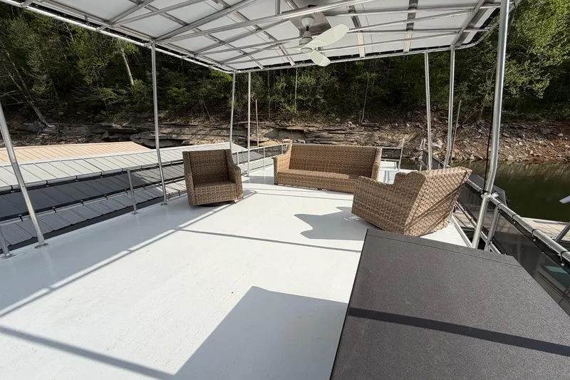 Slide: The Image of Upper deck of 1989 Sumerset 14x63 houseboat with wicker furniture and canopy. - 34