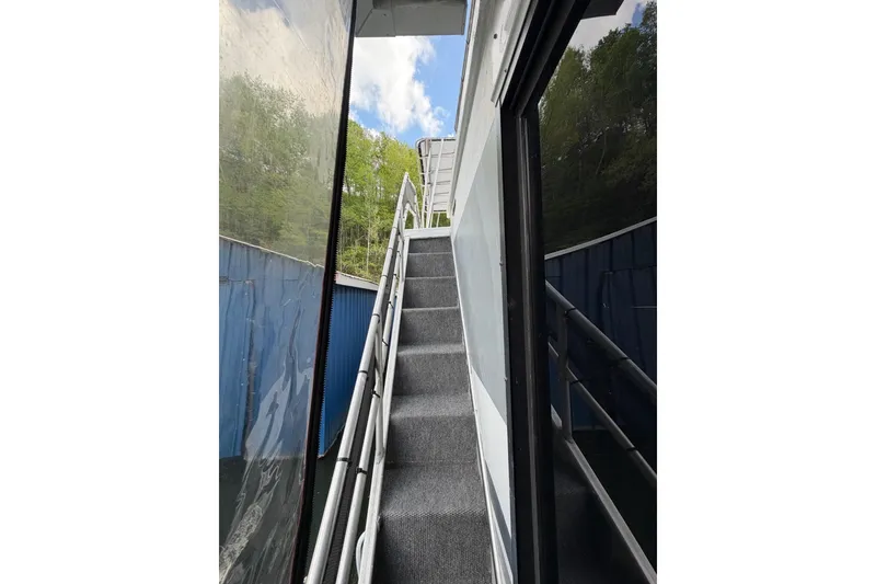 Slide: The Image of Staircase on a 1989 Sumerset 14x63 houseboat, leading to upper deck with scenic view. - 38