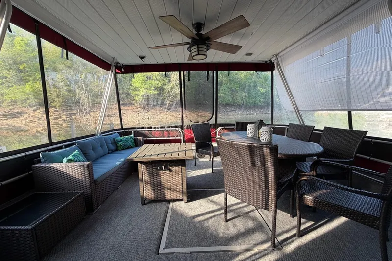 Slide: The Image of Cozy outdoor seating area on 1989 Sumerset 14x63 houseboat with wicker furniture and ceiling fan. - 4