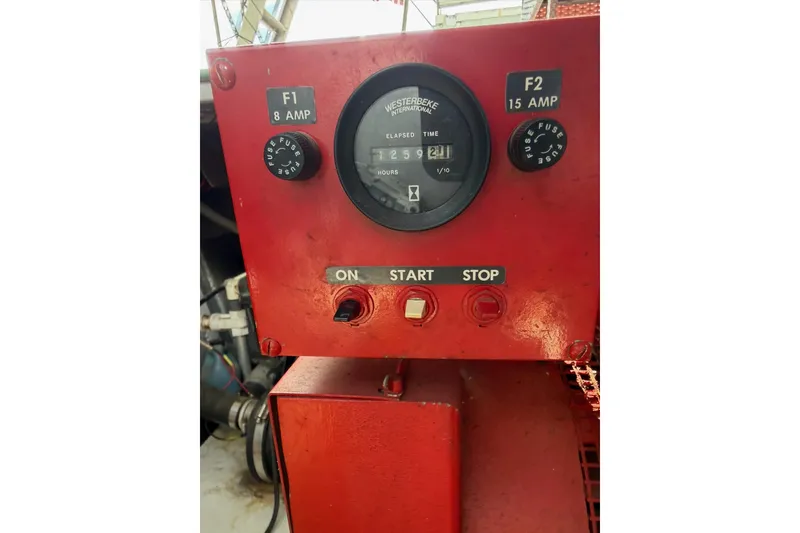 Slide: The Image of Red control panel with gauges and switches on a 1989 Sumerset 14x63 boat. - 41