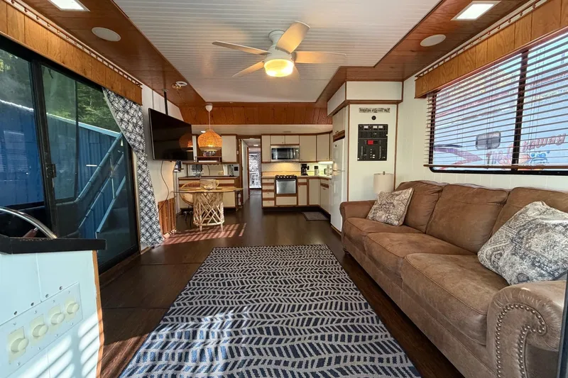 Slide: The Image of Interior of a 1989 Sumerset 14x63 houseboat with cozy living area and kitchen. - 5