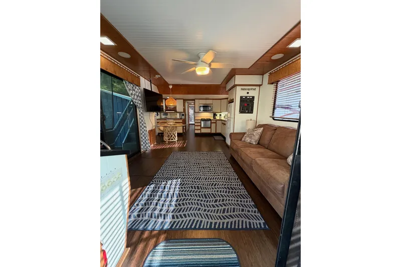 Slide: The Image of Interior of a 1989 Sumerset 14x63 houseboat with cozy living area and modern kitchen. - 6