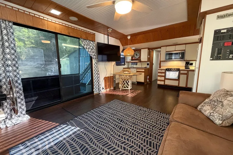 Slide: The Image of Interior of a 1989 Sumerset 14x63 houseboat with cozy living area and kitchen. - 7