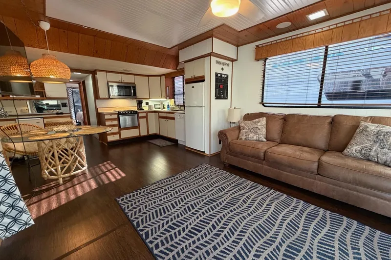 Slide: The Image of Interior of 1989 Sumerset 14x63 houseboat with cozy living area and kitchen. - 8