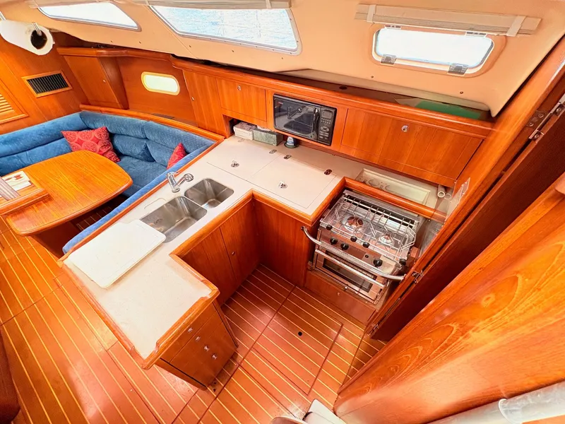 Slide: The Image of Interior of a 2003 Hunter 356 yacht with kitchen and seating area. - 18