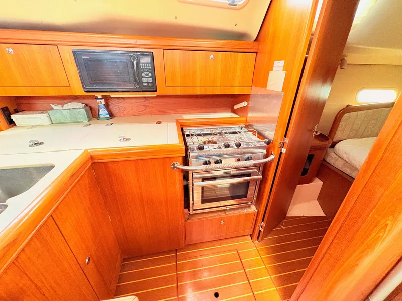 Slide: The Image of Galley area of a 2003 Hunter 356 yacht with stove and microwave. - 19