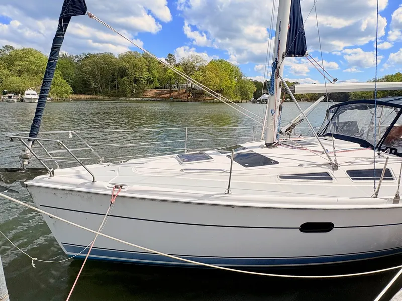 Slide: The Image of 2003 Hunter 356 sailboat on a calm lake under sunny skies. - 2