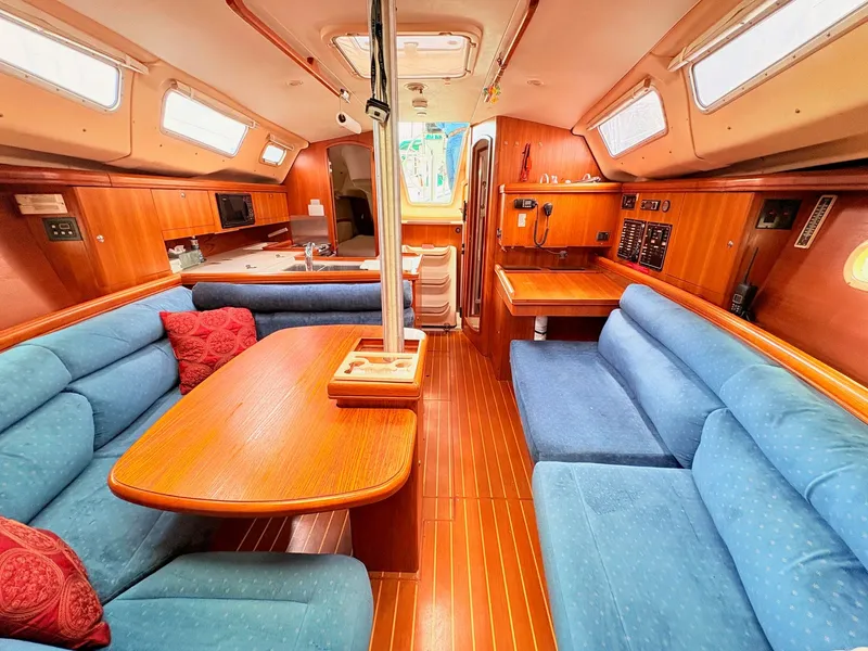 Slide: The Image of Interior of a 2003 Hunter 356 yacht with blue sofas. - 28
