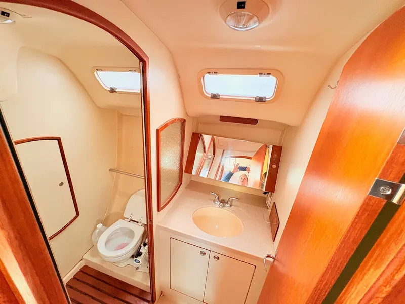 Slide: The Image of Interior of a 2003 Hunter 356 yacht, bathroom with sink and toilet. - 32