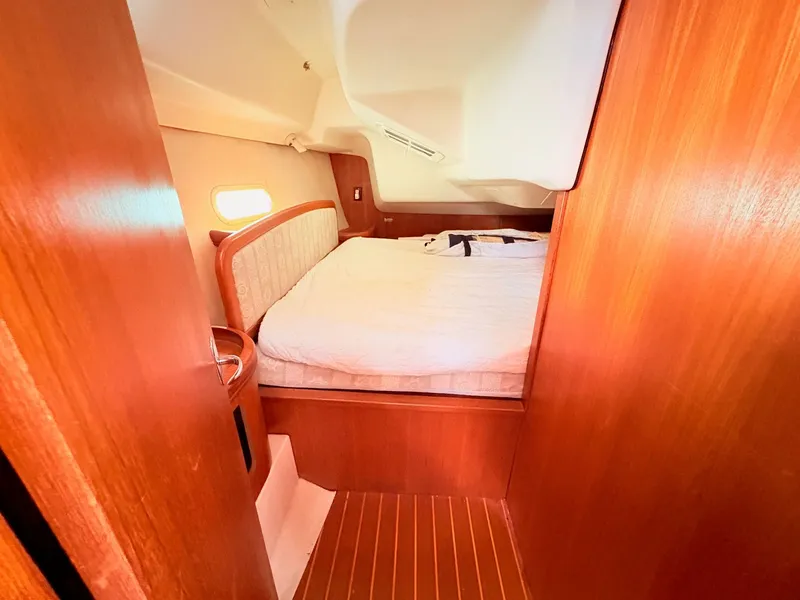 Slide: The Image of Interior of a 2003 Hunter 356 yacht featuring a cozy sleeping area. - 35