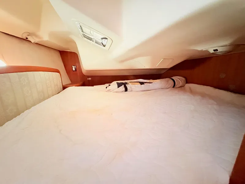 Slide: The Image of Interior of a 2003 Hunter 356 yacht featuring a cozy sleeping area. - 36