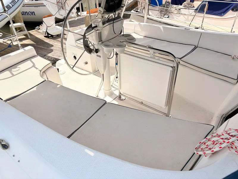 Slide: The Image of Interior of a 2003 Hunter 356 yacht with steering wheel and seating area. - 8