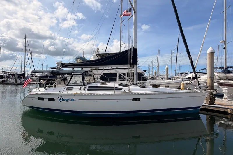 The Image of Hunter Legend 40.5 sailboat from 1998 docked in a marina under a blue sky. - 0
