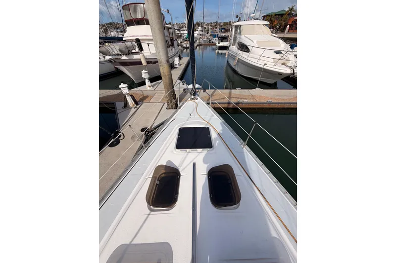 Slide: The Image of 1998 Hunter Legend 40.5 sailboat docked in a marina, surrounded by other boats. - 12