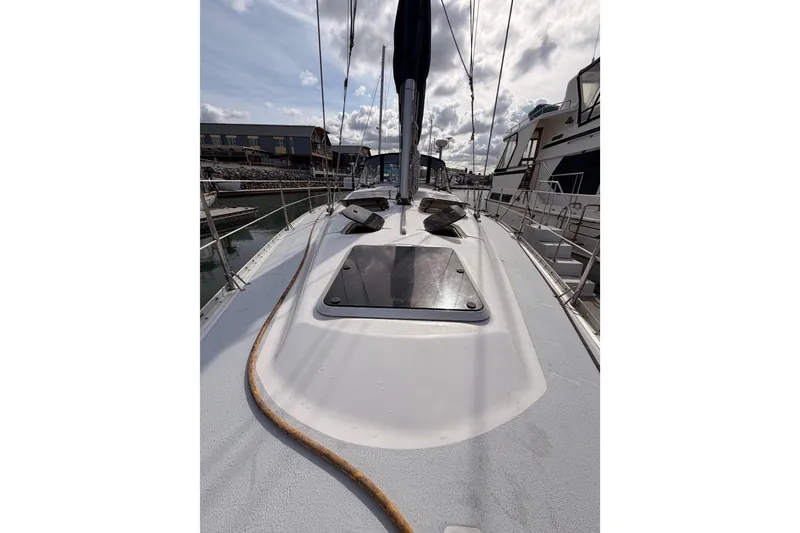 Slide: The Image of 1998 Hunter Legend 40.5 sailboat deck view with marina background. - 16