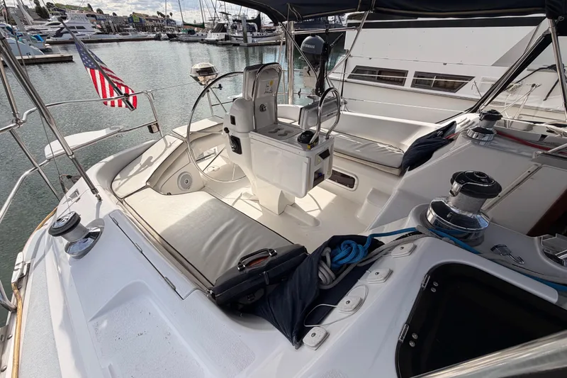 Slide: The Image of Cockpit of 1998 Hunter Legend 40.5 sailboat docked in marina, featuring steering wheel and seating. - 19
