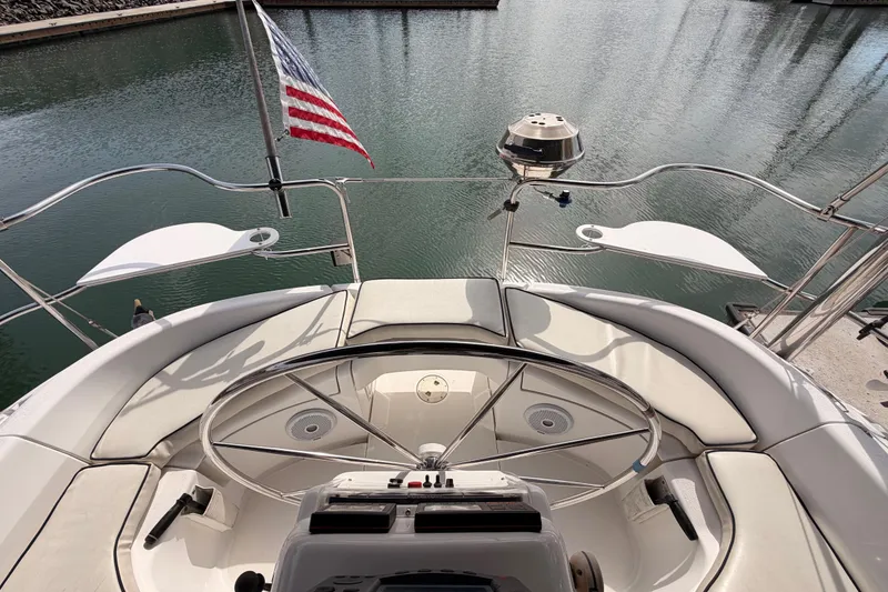 Slide: The Image of 1998 Hunter Legend 40.5 yacht cockpit with American flag, docked in marina. - 21
