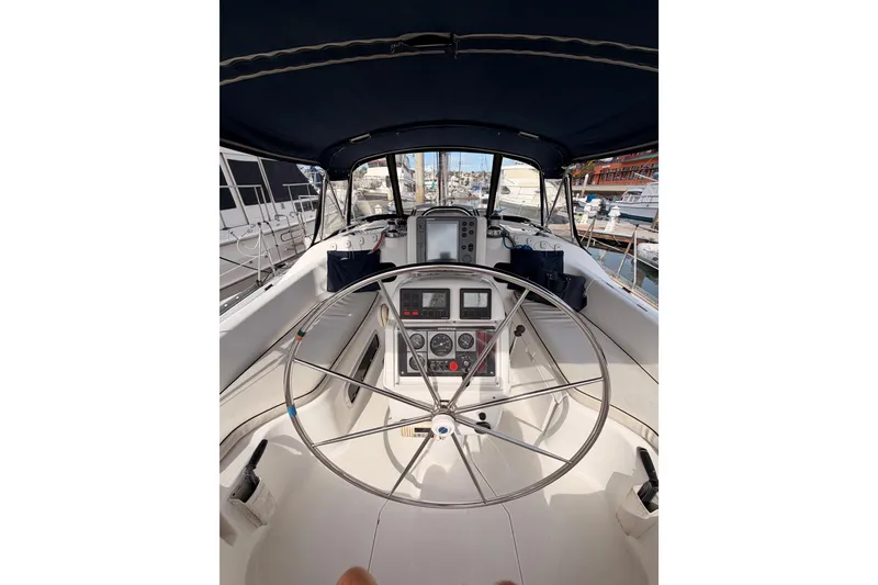Slide: The Image of Cockpit view of 1998 Hunter Legend 40.5 sailboat with steering wheel and navigation instruments. - 23